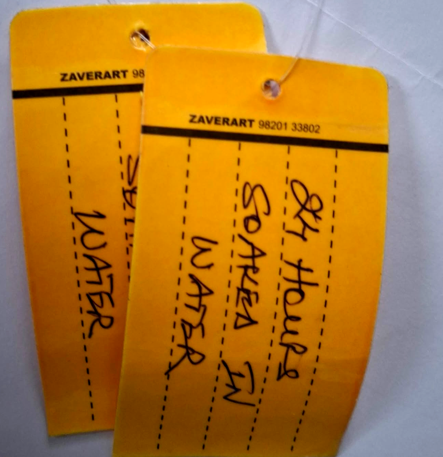 Laminated tags after 24 hours soaked in water, handwriting still legible